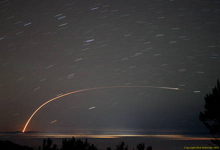 这张长时间曝光的图片记录了三角洲II型火箭推送NASA的OCO-2卫星进入地球轨道的长长轨迹，从距离发射点200千米处拍摄。空中的其他短长条是星轨。